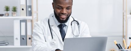 health care professional working on a laptop